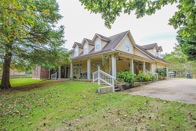 cape cod house with covered porch and a front lawn