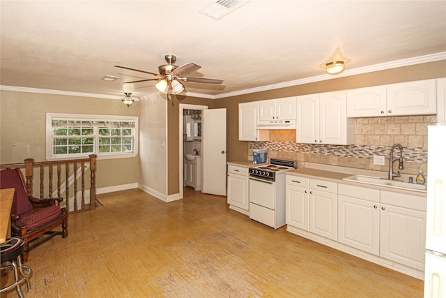 kitchen with sink, white appliances, light hardwood / wood-style flooring, tasteful backsplash, and white cabinets