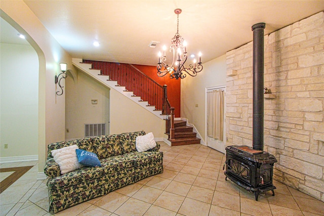 living room featuring light tile patterned floors and a wood stove