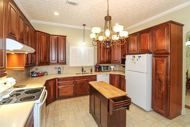 kitchen with a kitchen island, decorative light fixtures, wooden counters, ornamental molding, and white appliances