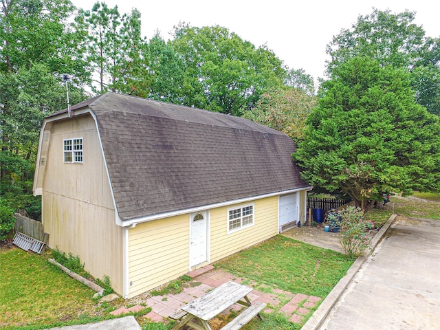 view of outbuilding with a garage and a lawn