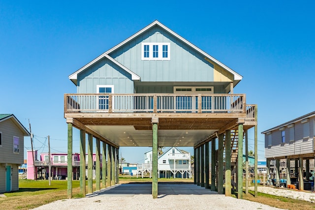 view of front of property with a balcony, a front yard, and a wooden deck