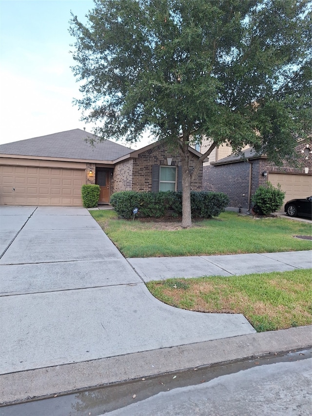 ranch-style house featuring a front yard and a garage