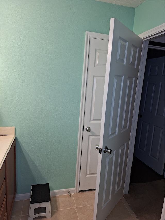 bathroom featuring vanity and tile floors