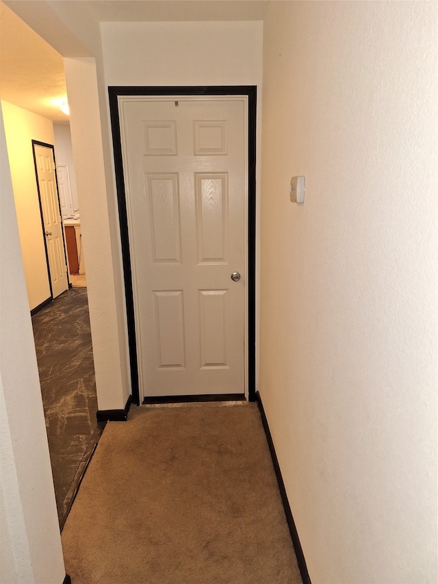 corridor with dark tile floors