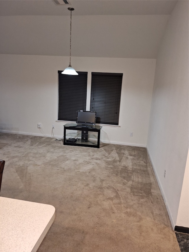 carpeted living room featuring lofted ceiling