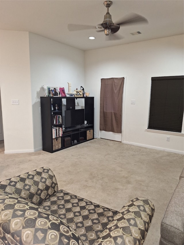 interior space with ceiling fan and light colored carpet