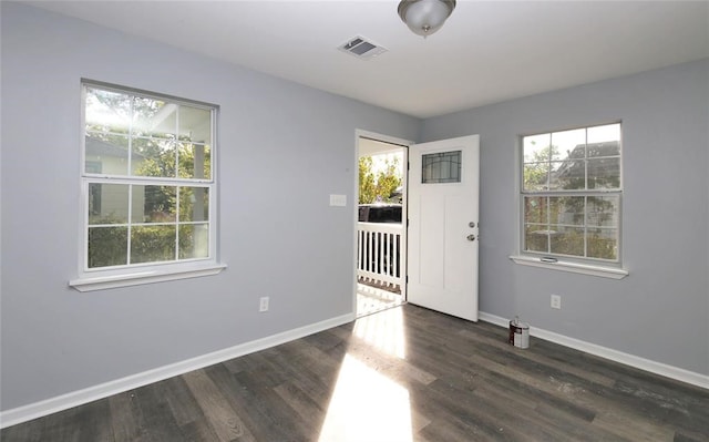 unfurnished room with dark hardwood / wood-style flooring