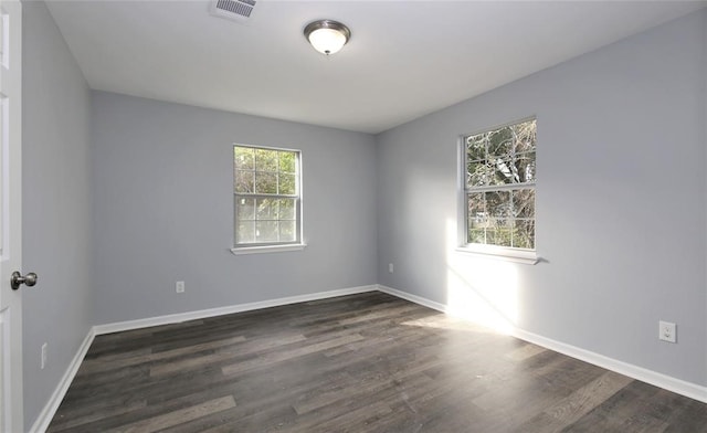 empty room with dark wood-type flooring