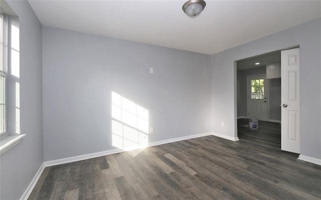 spare room with dark wood-type flooring