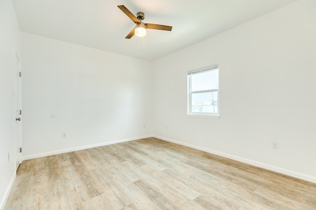 empty room featuring ceiling fan and light hardwood / wood-style flooring