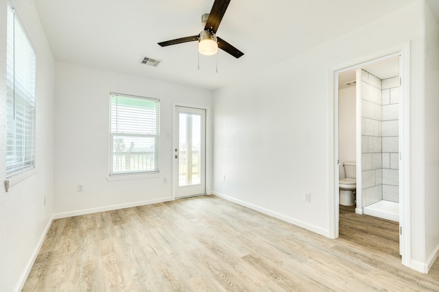 unfurnished bedroom with ceiling fan, light hardwood / wood-style flooring, ensuite bath, and access to exterior