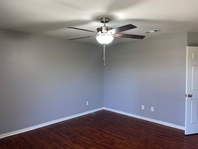 spare room with ceiling fan and dark hardwood / wood-style flooring