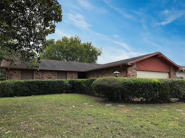 ranch-style home with a front lawn and a garage