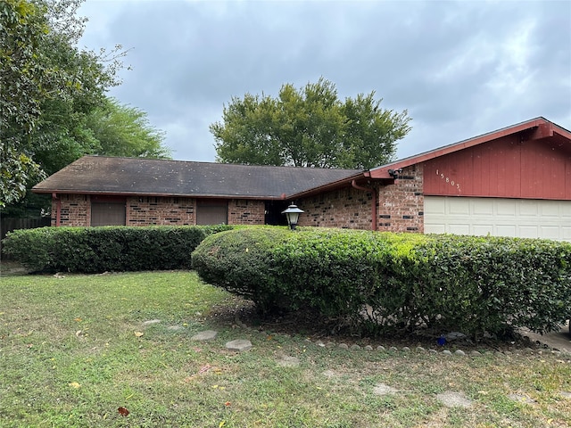 single story home with a front yard and a garage