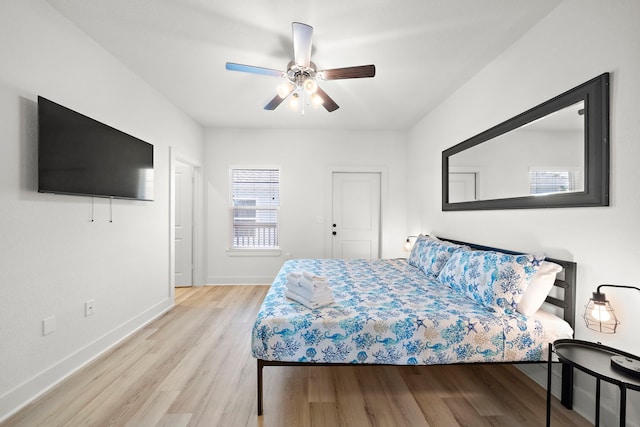 bedroom with light hardwood / wood-style floors and ceiling fan