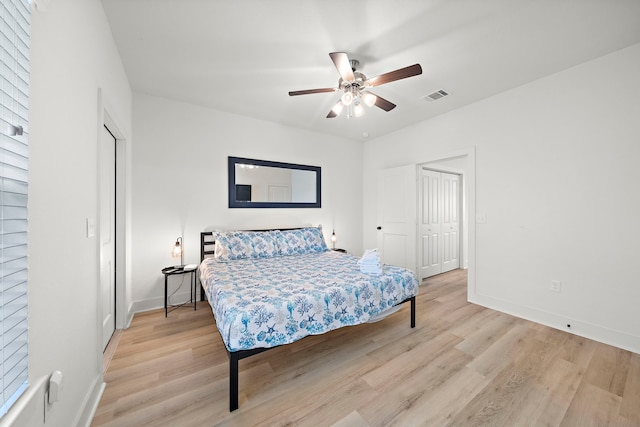 bedroom with a closet, ceiling fan, and light wood-type flooring