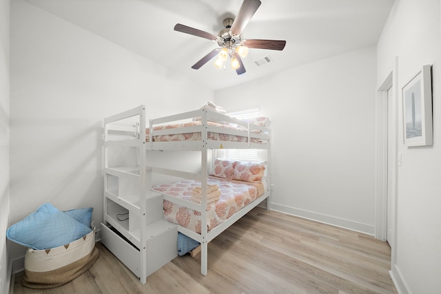 bedroom with light hardwood / wood-style flooring and ceiling fan