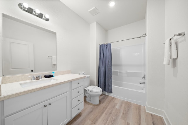 full bathroom with hardwood / wood-style flooring, toilet, shower / bath combo, and vanity