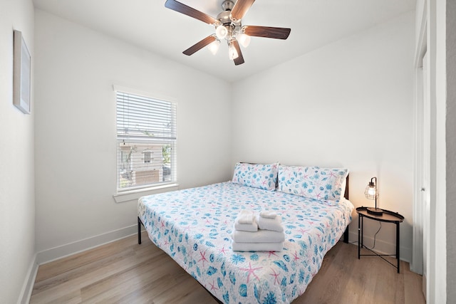 bedroom with ceiling fan and light wood-type flooring