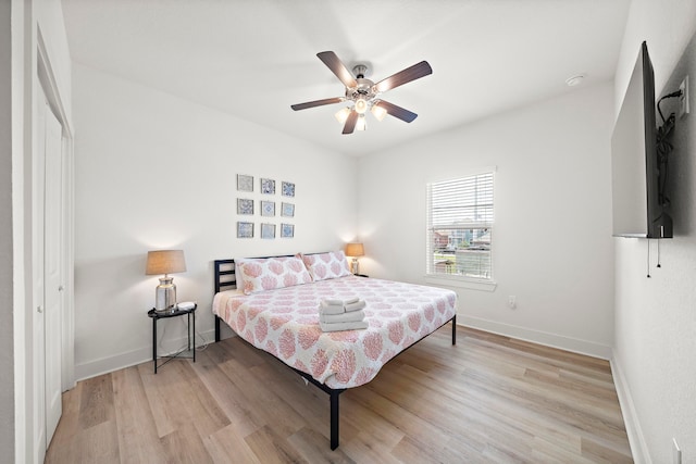 bedroom featuring a closet, ceiling fan, and light wood-type flooring