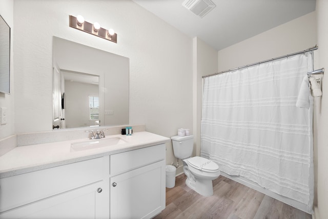 bathroom with vanity, hardwood / wood-style floors, and toilet