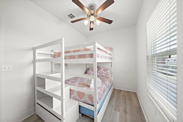 bedroom with ceiling fan and light wood-type flooring