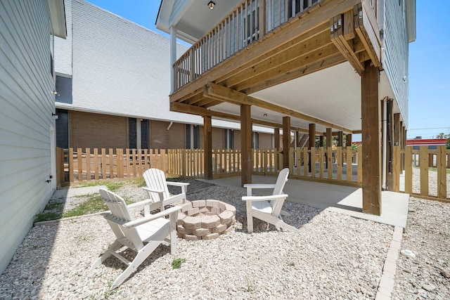 view of patio featuring a balcony and a fire pit