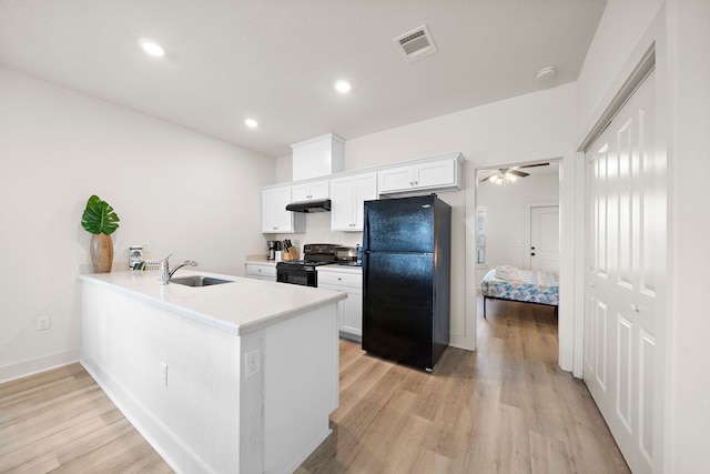 kitchen with white cabinets, ceiling fan, light hardwood / wood-style floors, and black appliances