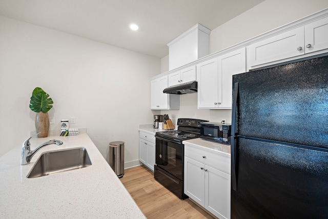 kitchen with white cabinetry, light hardwood / wood-style flooring, black appliances, and sink