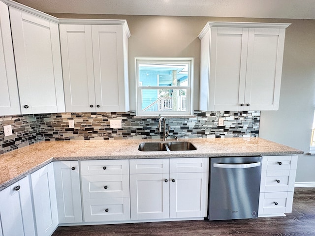 kitchen with stainless steel dishwasher, white cabinetry, and dark hardwood / wood-style flooring