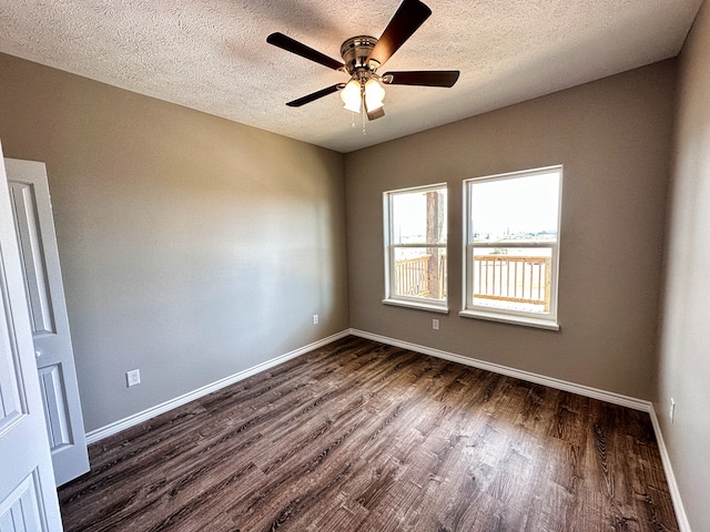 empty room with dark hardwood / wood-style floors, a textured ceiling, and ceiling fan