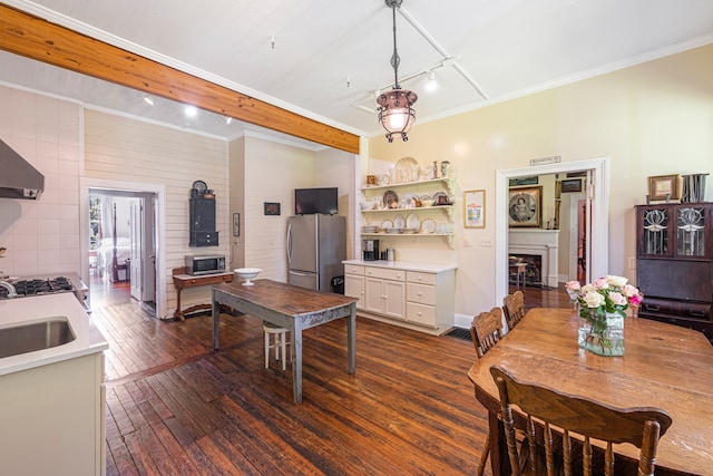 dining area with dark hardwood / wood-style floors, ornamental molding, and sink