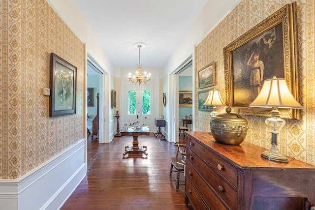 hallway featuring french doors, a chandelier, and dark hardwood / wood-style floors