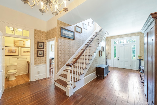 entrance foyer featuring hardwood / wood-style floors and an inviting chandelier