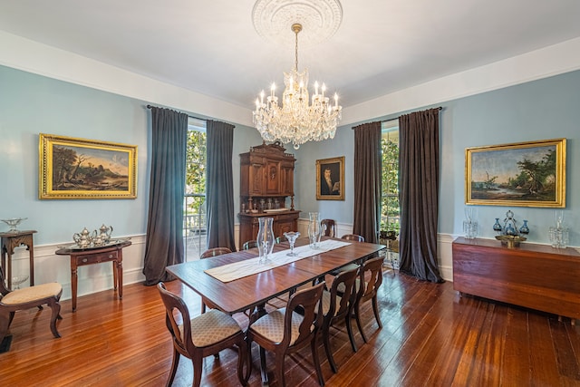 dining area featuring a notable chandelier and dark hardwood / wood-style flooring