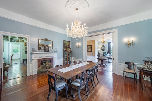 dining room featuring a fireplace, a chandelier, and dark hardwood / wood-style floors