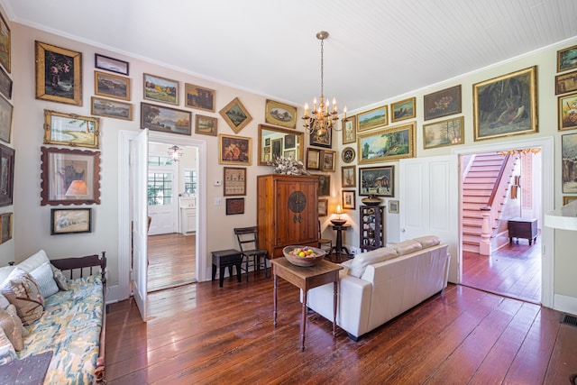 living room with a chandelier, dark hardwood / wood-style floors, and crown molding