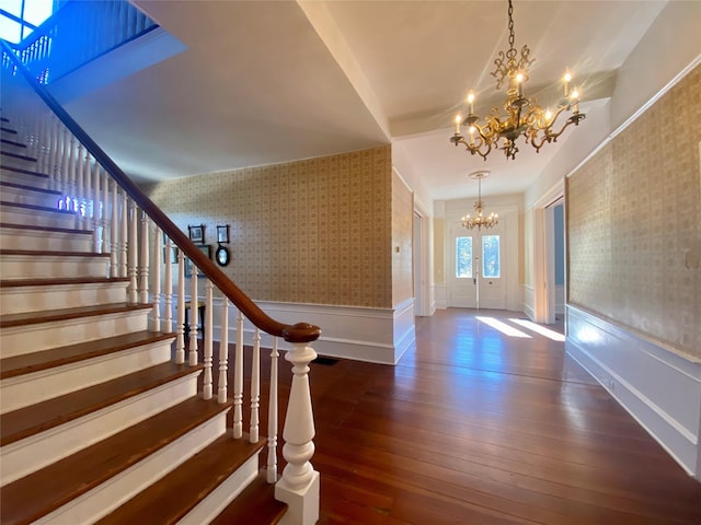 entrance foyer featuring a notable chandelier and dark hardwood / wood-style floors