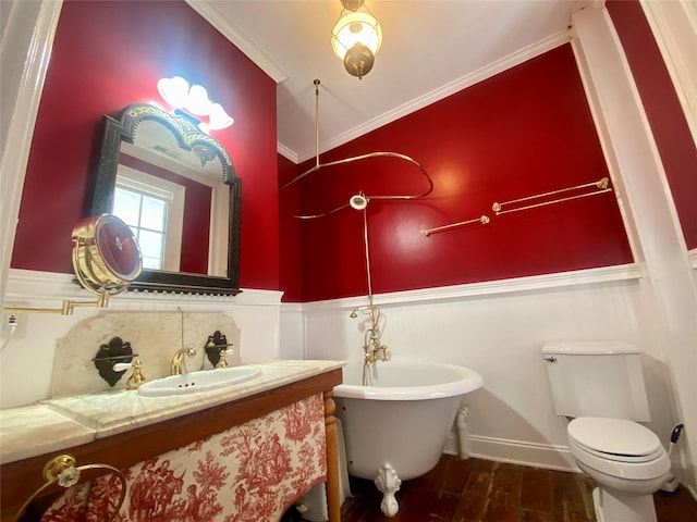 bathroom featuring a bathing tub, wood-type flooring, toilet, vanity, and ornamental molding