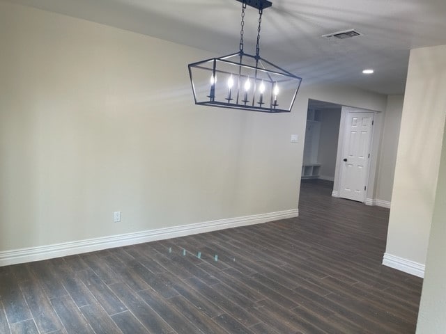 interior space with an inviting chandelier and dark hardwood / wood-style flooring