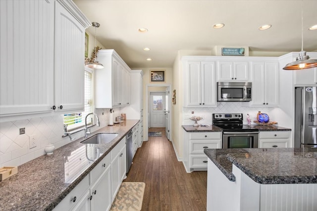 kitchen with white cabinetry, tasteful backsplash, stainless steel appliances, and pendant lighting