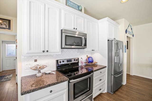 kitchen featuring white cabinetry, dark wood-type flooring, tasteful backsplash, and stainless steel appliances