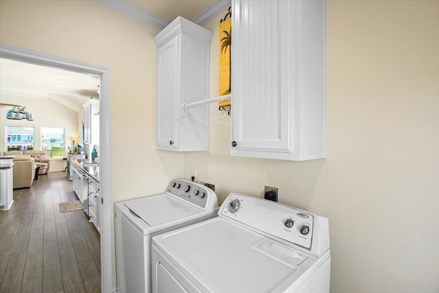 laundry area with wood-type flooring, hookup for an electric dryer, ornamental molding, cabinets, and washer and clothes dryer