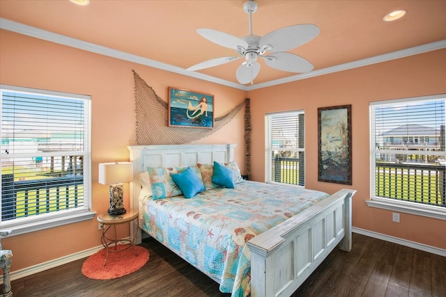 bedroom featuring dark wood-type flooring, ceiling fan, ornamental molding, and multiple windows