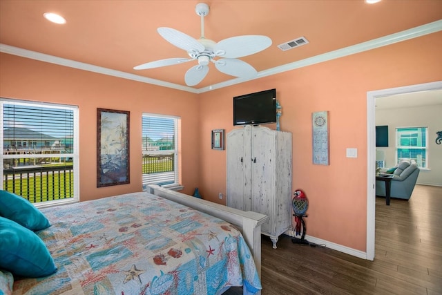 bedroom with ceiling fan, dark hardwood / wood-style flooring, and ornamental molding