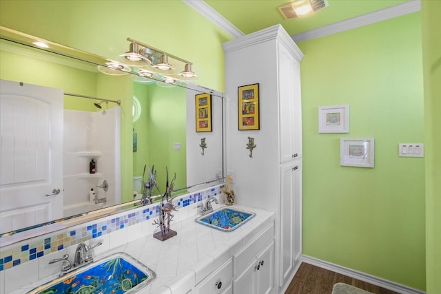 bathroom featuring crown molding, bathing tub / shower combination, and wood-type flooring