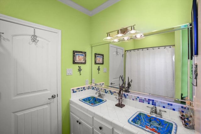 bathroom with ornamental molding and vanity