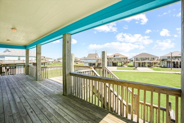 wooden deck with a lawn