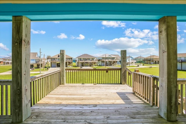 wooden terrace featuring a yard